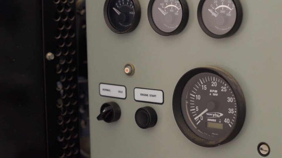 A close-up of analog dial gauges on an equipment control panel.