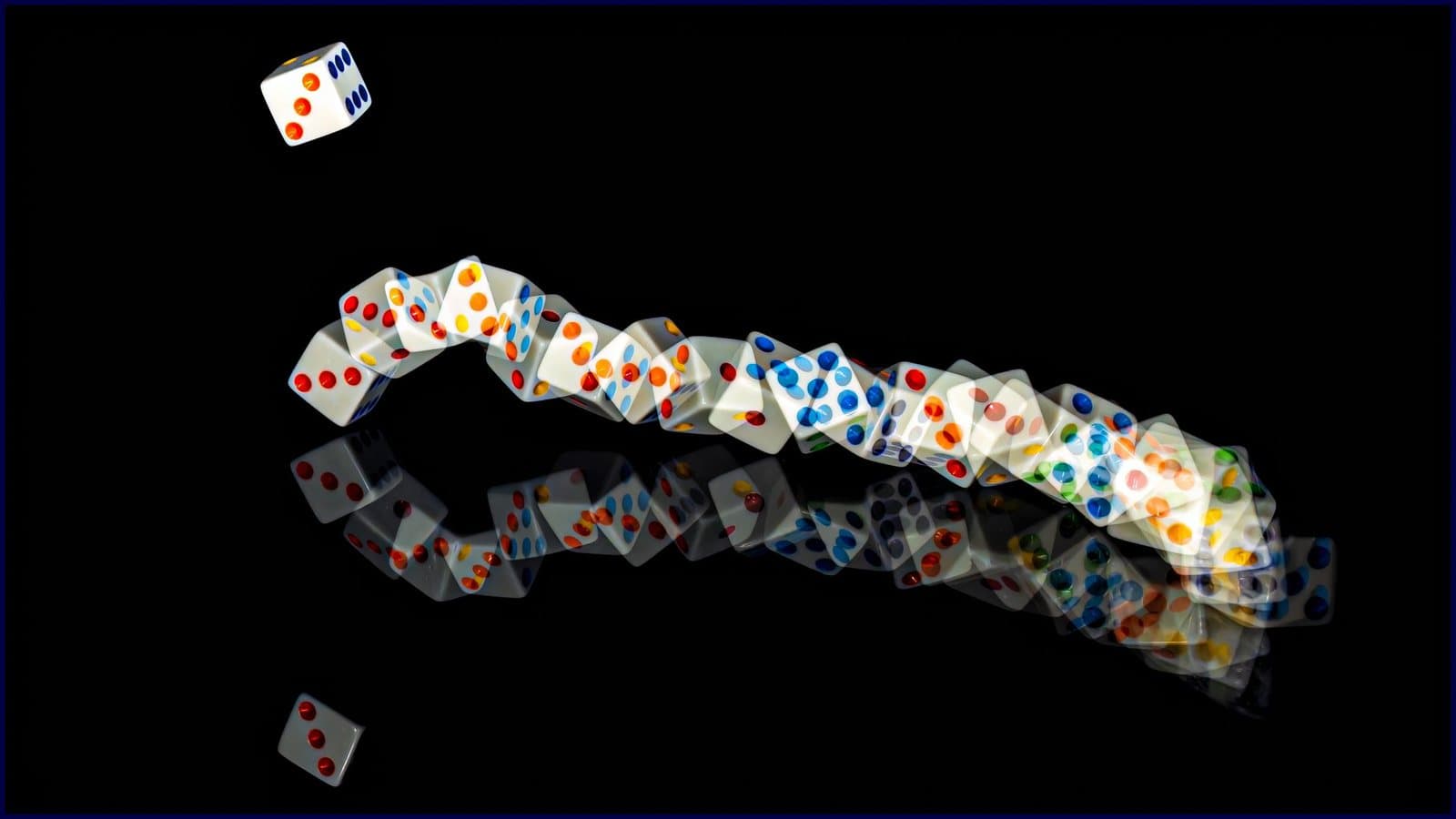 A trail of dice tumbling across a black surface, each one landing differently.